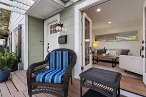 Deck with a pergola and an outdoor living space