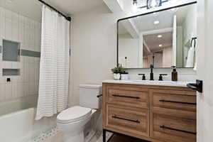 Full bathroom with shower / bath combo with shower curtain, vanity, tile patterned floors, and recessed lighting