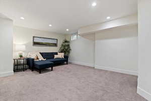 Living area with carpet flooring and recessed lighting