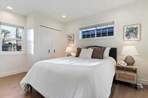 Bedroom featuring a closet, light wood-type flooring, and recessed lighting