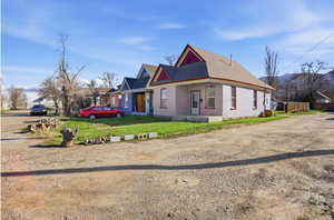 View of home's exterior and road surrounding the end of the street/corner lot.