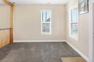 Living room with large windows and carpet