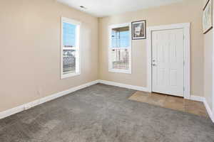 Living room with large windows and carpet