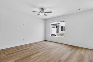 Unfurnished room featuring light wood-style floors and a ceiling fan