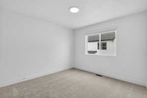 Unfurnished room featuring carpet floors and baseboards
