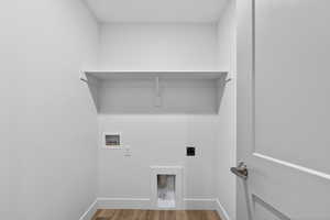 Laundry room with light wood-type flooring, washer hookup, and hookup for an electric dryer