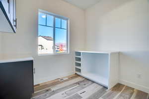 Empty room with light wood-style flooring and baseboards
