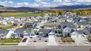 Aerial perspective of suburban area featuring a mountainous background