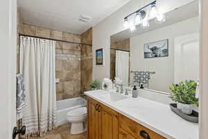 Full bath featuring shower / tub combo and vanity