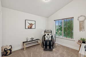 Sitting room featuring lofted ceiling and carpet