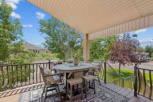 Wooden deck featuring outdoor dining space