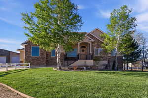 View of front of house with stone siding and stucco siding