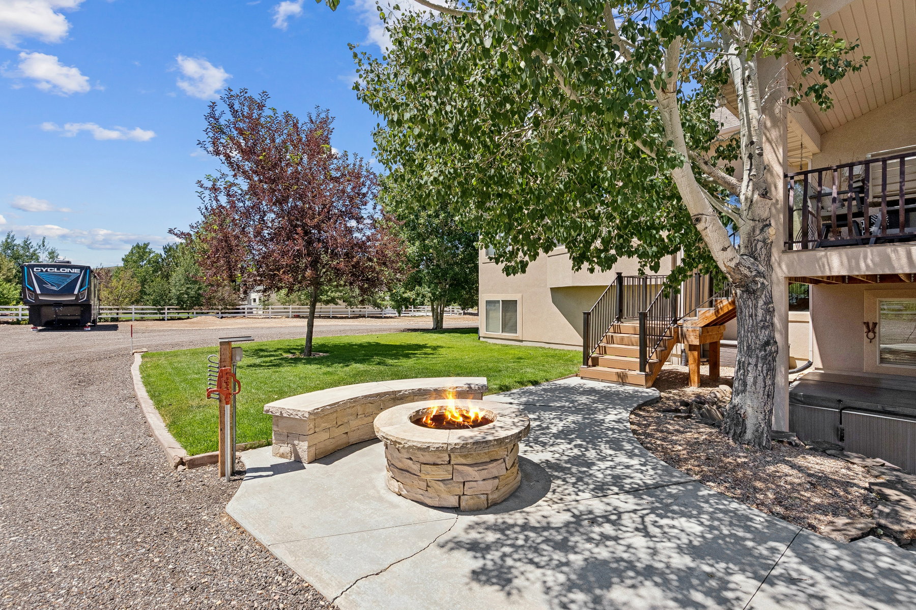 View of patio featuring stairway and an outdoor fire pit