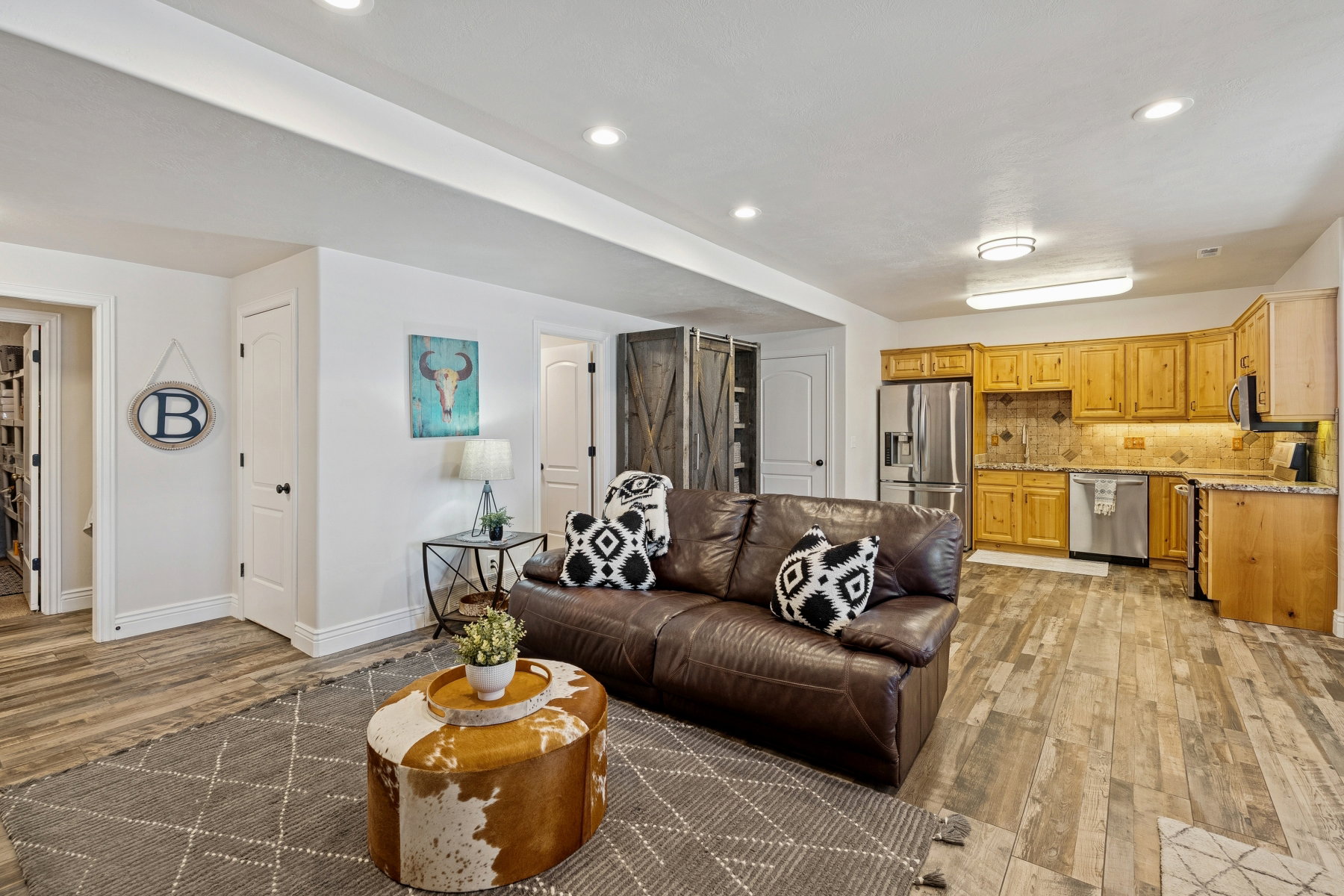 Living area featuring light wood finished floors and recessed lighting