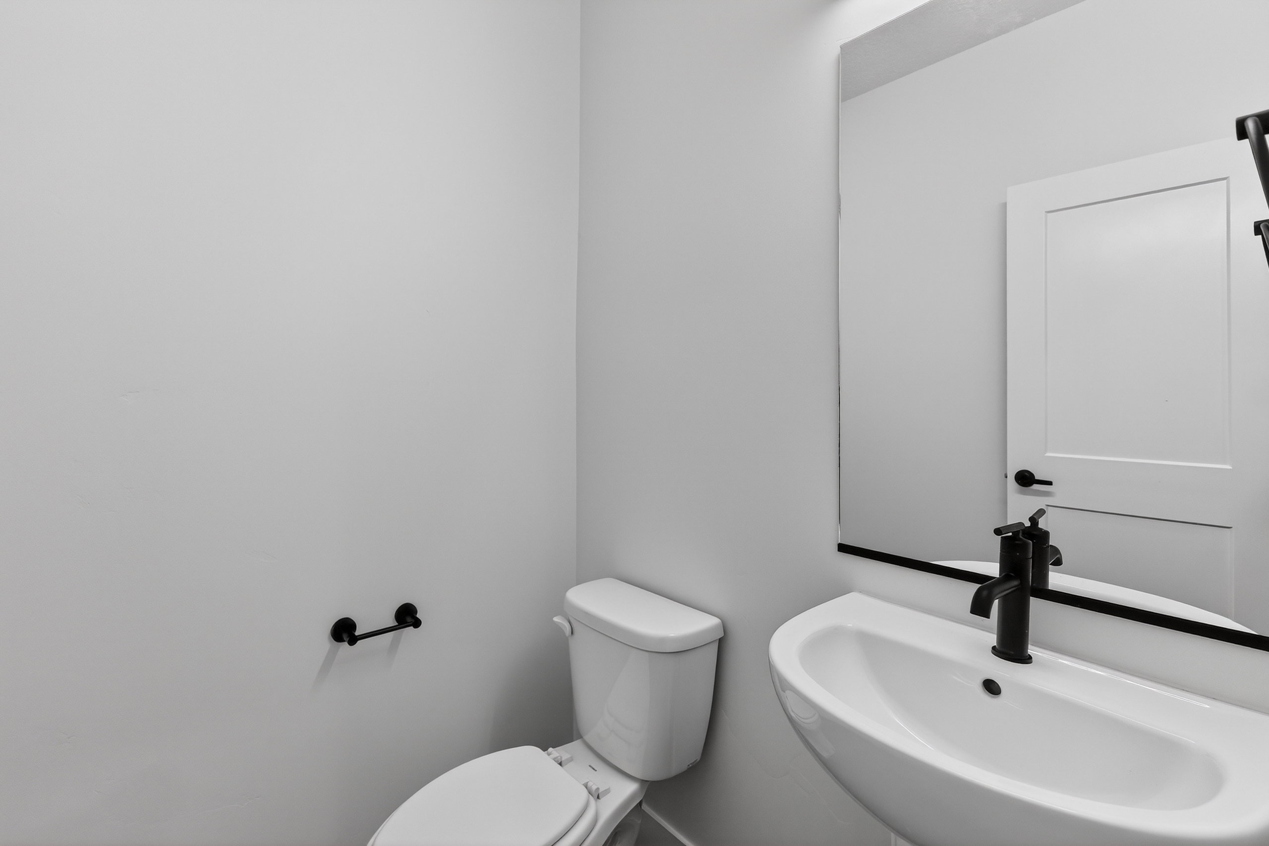 Half bathroom featuring toilet and a sink