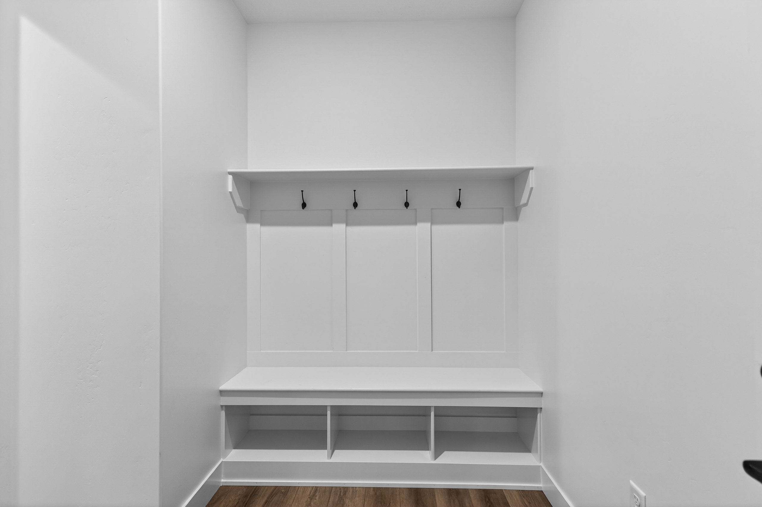 Mudroom featuring dark wood-type flooring and baseboards