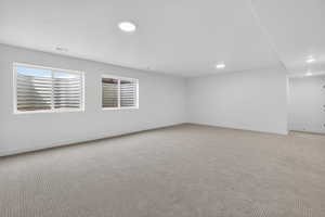 Empty room with carpet and baseboards