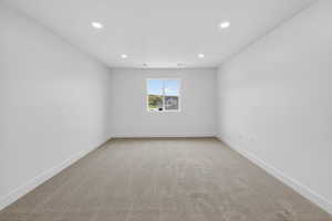 Unfurnished room with light carpet and recessed lighting