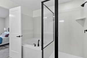 Bathroom with ensuite bath, a stall shower, a garden tub, and a textured ceiling