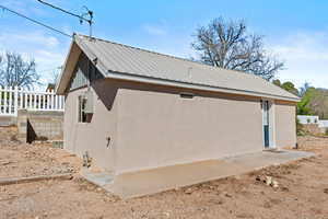 View of property exterior featuring stucco siding and a metal roof