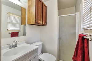 Full bath with vanity and a shower stall