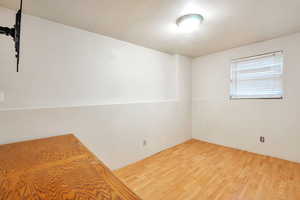 Unfurnished bedroom featuring wood finished floors
