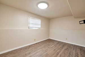 Empty room featuring baseboards and light wood-style flooring