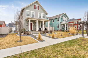 View of front of home with a gate, stucco siding, and a porch