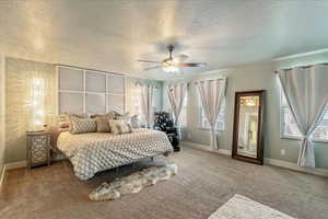 Carpeted bedroom with a textured ceiling and ceiling fan