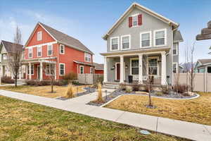 Traditional-style house with a porch, stucco siding, and board and batten siding