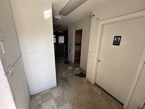 Corridor featuring light flooring