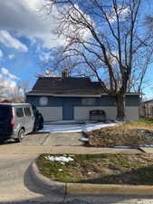 View of front of property with roof with shingles