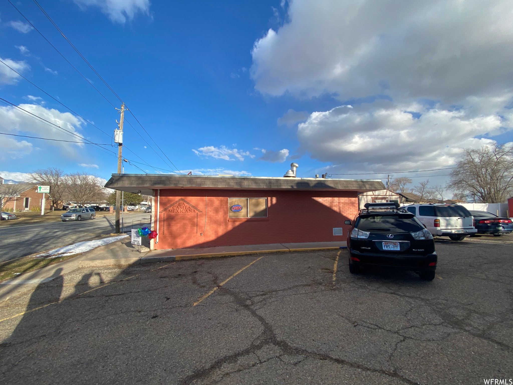 View of commercial location featuring uncovered parking