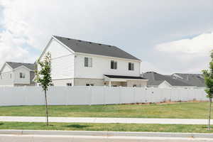 Back of house with fully-fenced yard