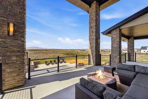 View of patio / terrace with area for grilling and an outdoor living space with a fire pit