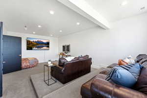 Living area with recessed lighting, carpet floors, and beamed ceiling