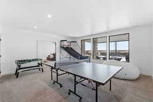 Game room with light colored carpet and recessed lighting
