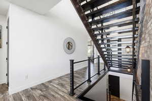 Staircase featuring baseboards and wood finished floors