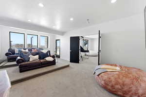 Bedroom with light carpet and recessed lighting
