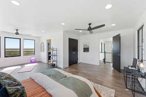 Bedroom with recessed lighting, ceiling fan, and wood finished floors