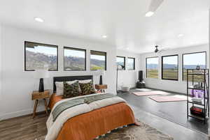 Bedroom with a mountain view, ceiling fan, and recessed lighting