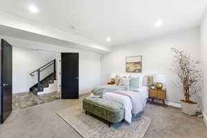 Bedroom with light carpet and recessed lighting