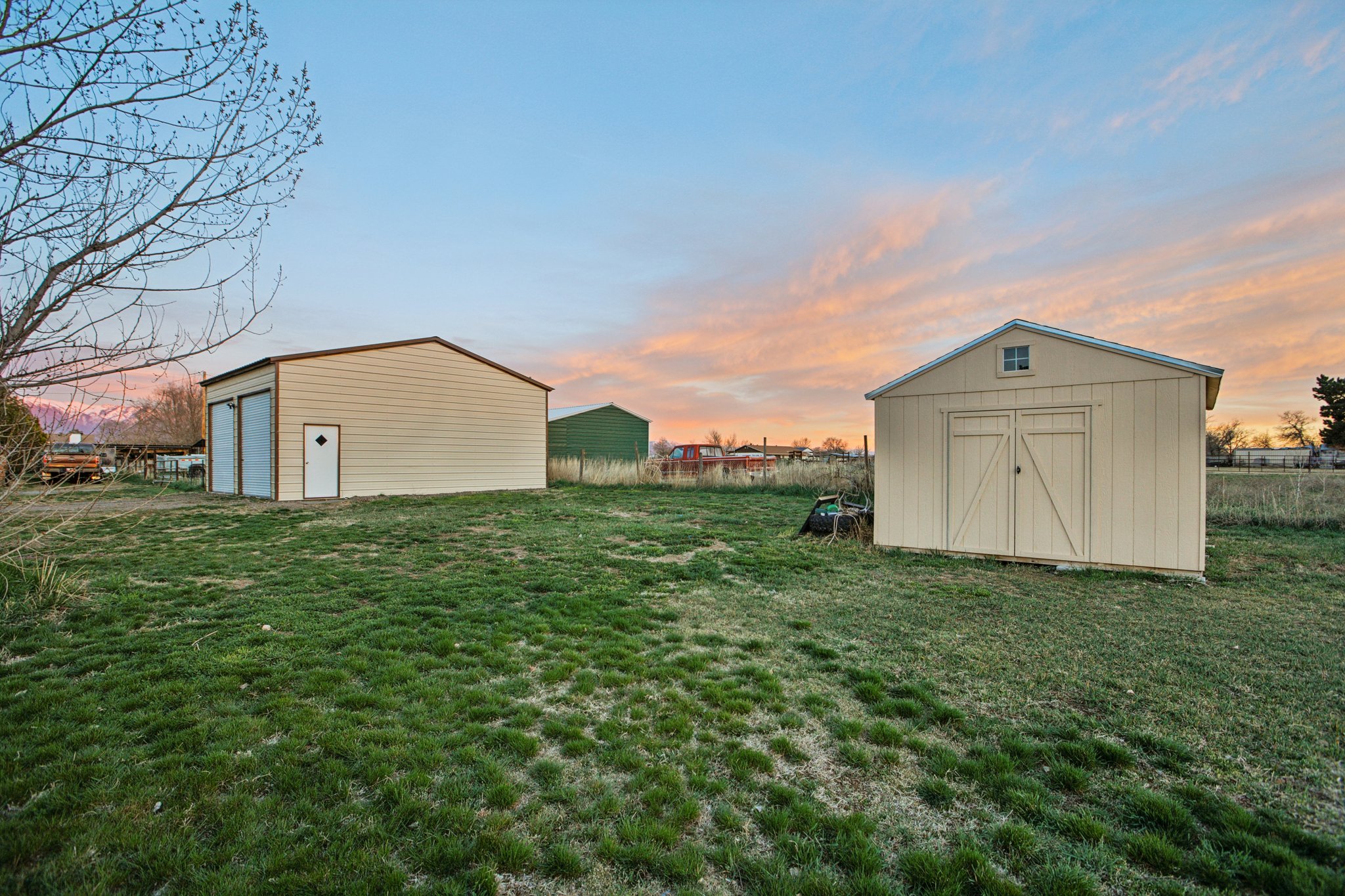 View of yard with a garage and a storage unit
