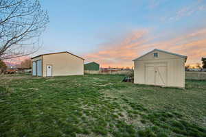 View of yard with a garage and a storage unit