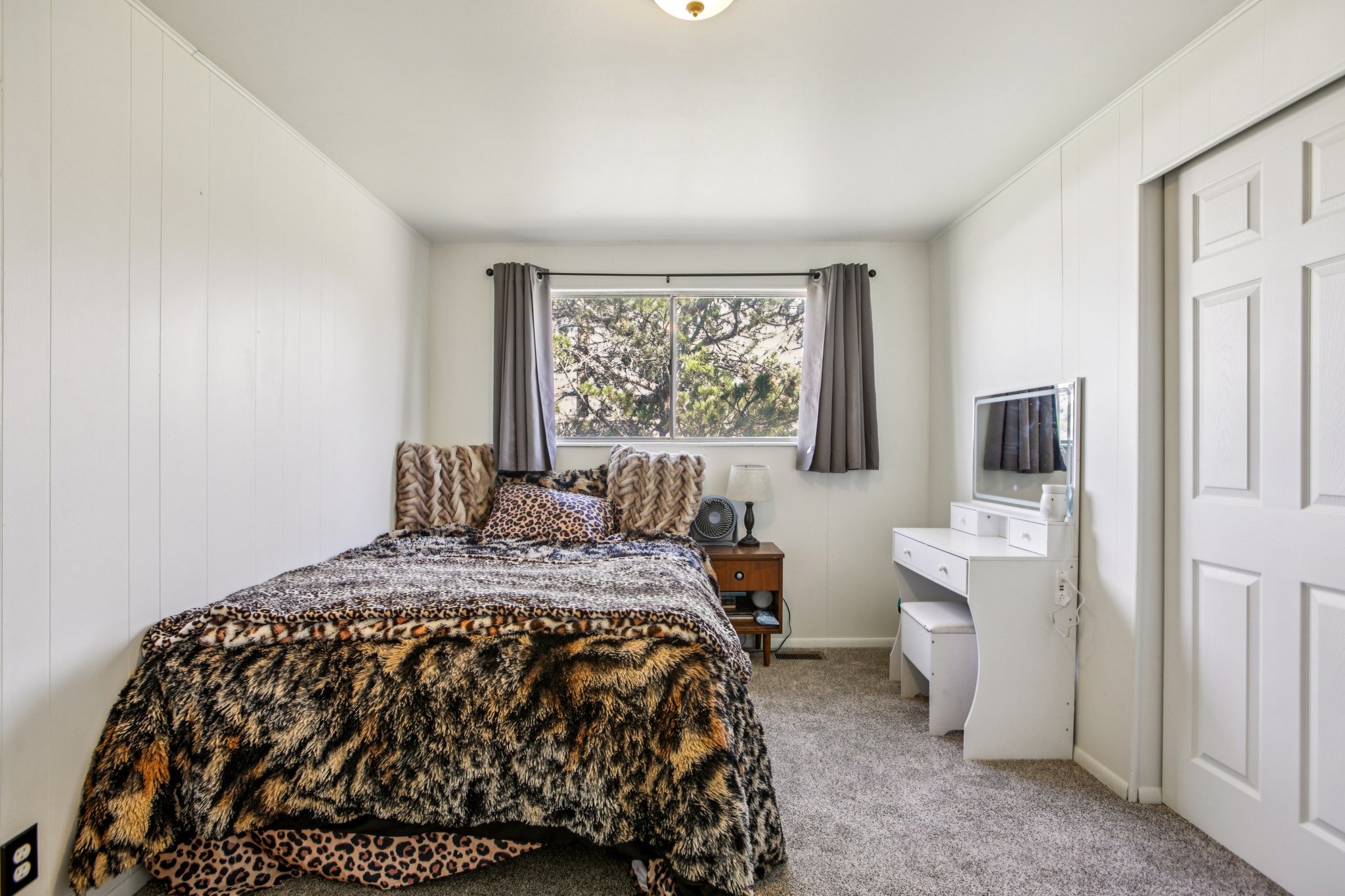 Bedroom featuring light carpet and baseboards