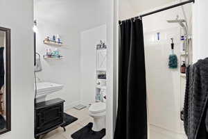 Bathroom with a stall shower and light tile patterned floors