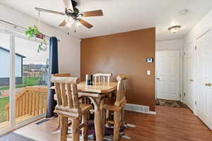 Dining area featuring wood finished floors and ceiling fan