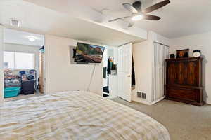 Bedroom featuring light colored carpet and a ceiling fan