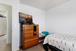 Bedroom featuring carpet floors and baseboards