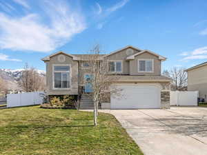 View of front of house featuring a gate, driveway, a garage, stucco siding, and a mountain view